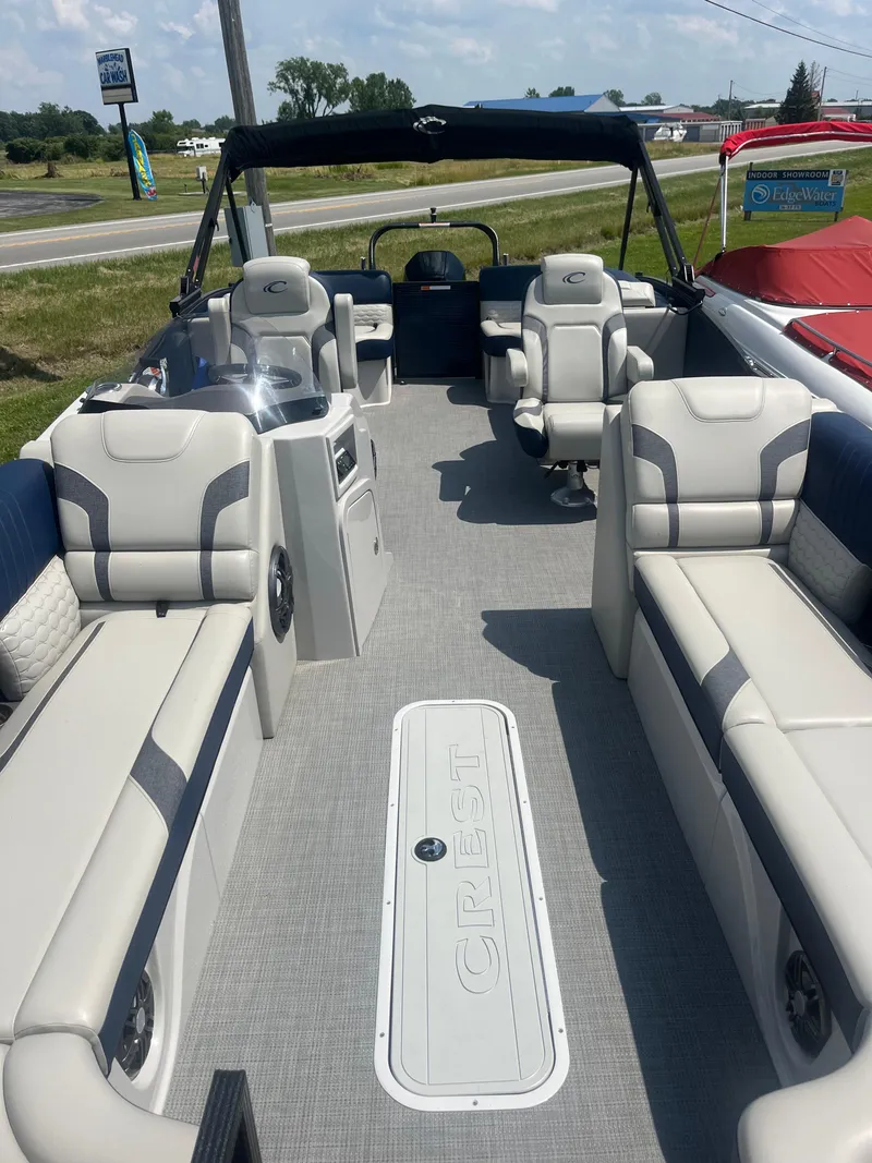 Slide: The Image of 2022 Crest Caribbean LX 250 CP3 pontoon boat with spacious seating and modern design. - 4