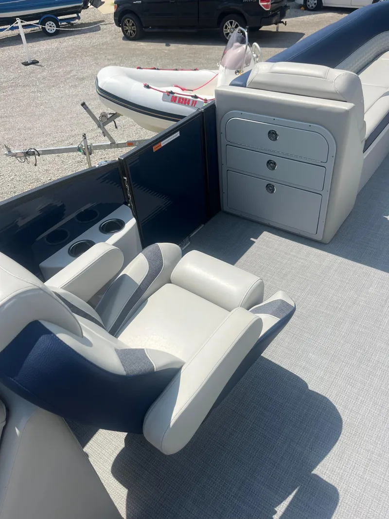 Slide: The Image of 2022 Crest Caribbean LX 250 CP3 boat interior with seating and storage compartments. - 7