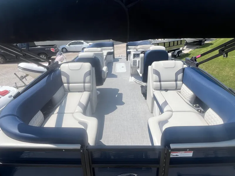 Slide: The Image of 2022 Crest Caribbean LX 250 CP3 pontoon boat with spacious seating and modern design. - 9
