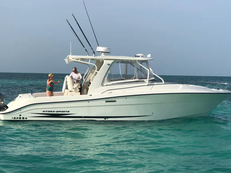 The Image of 2008 Hydra-Sports 3500VX boat on clear turquoise water, with two people onboard. - 22