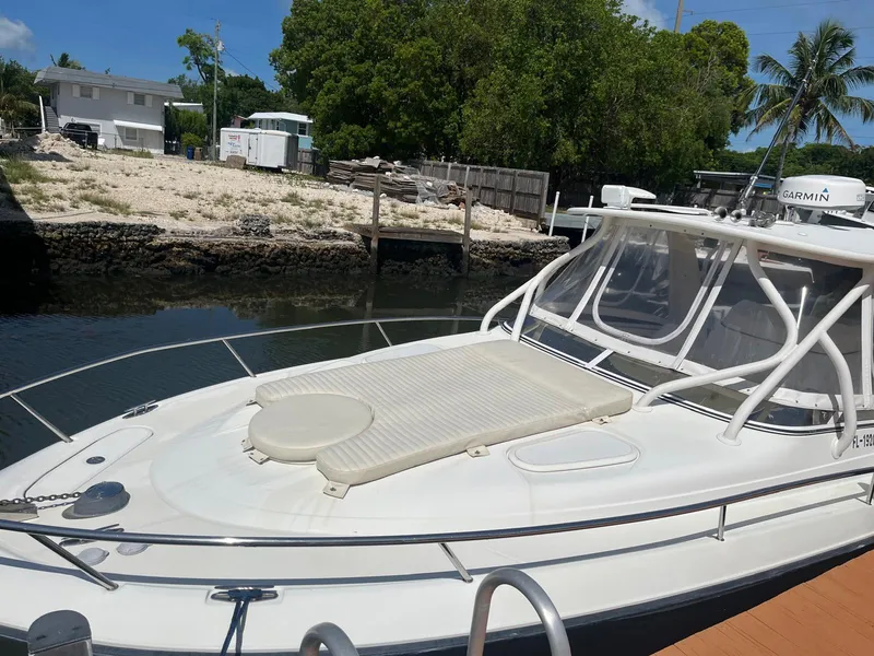 Slide: The Image of 2008 Hydra-Sports 3500VX boat docked near a waterfront property. - 23