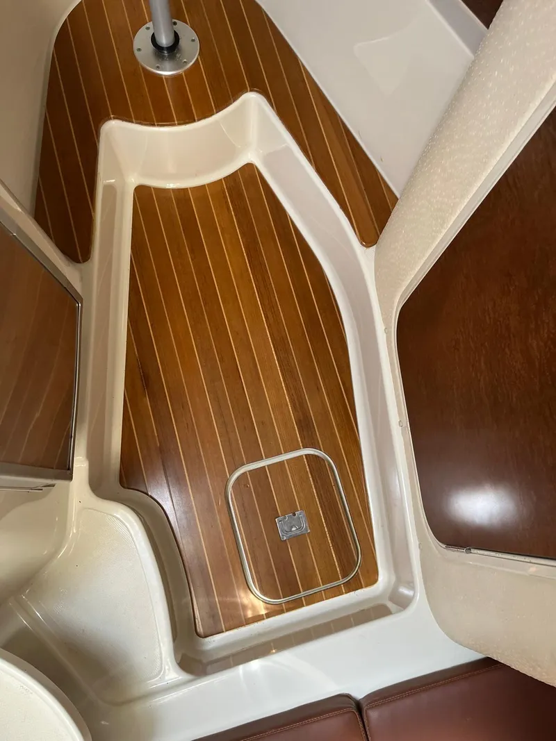 Slide: The Image of 2008 Hydra-Sports 3500VX cabin interior with wood flooring and storage hatch. - 26