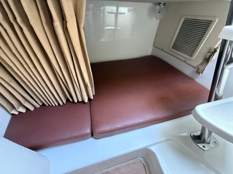 Slide: The Image of 2008 Hydra-Sports 3500VX cabin interior with brown cushions and beige curtains. - 32