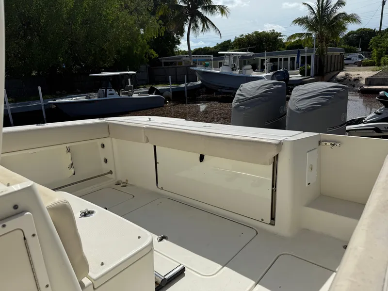 Slide: The Image of 2008 Hydra-Sports 3500VX boat interior with seating, docked near palm trees. - 35