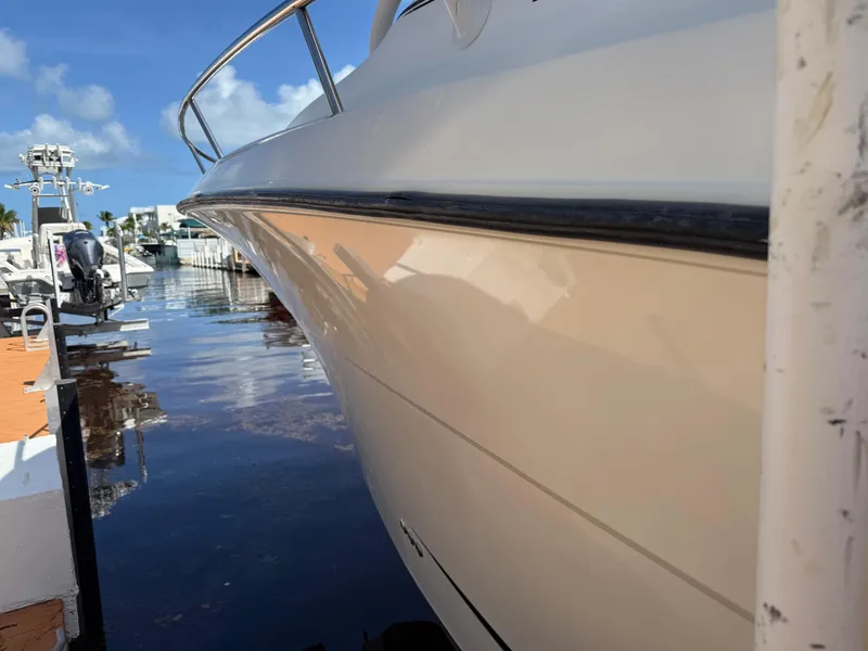 Slide: The Image of 2008 Hydra-Sports 3500VX boat docked, reflecting sunlight on calm water. - 36