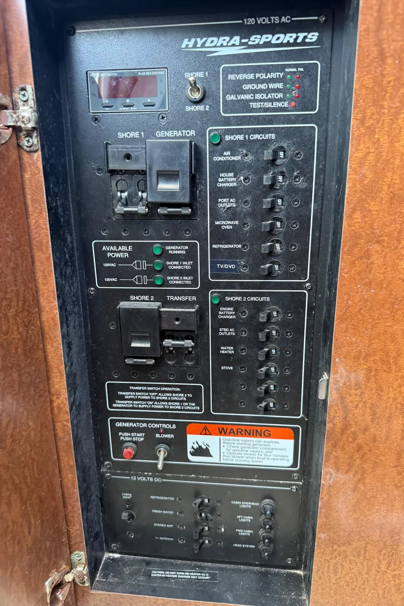 Slide: The Image of Electrical control panel of a 2008 Hydra-Sports 3500VX boat, featuring various switches and warnings. - 40