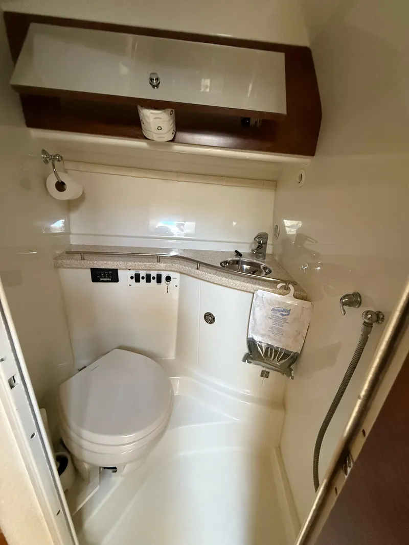 Slide: The Image of 2008 Hydra-Sports 3500VX boat bathroom with toilet, sink, and storage cabinet. - 46