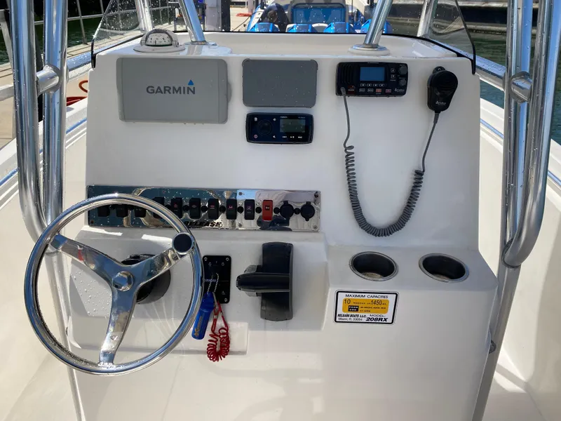 Slide: The Image of Boat console with Garmin GPS, steering wheel, and communication devices on Release 208 SXC, 2018 model. - 11