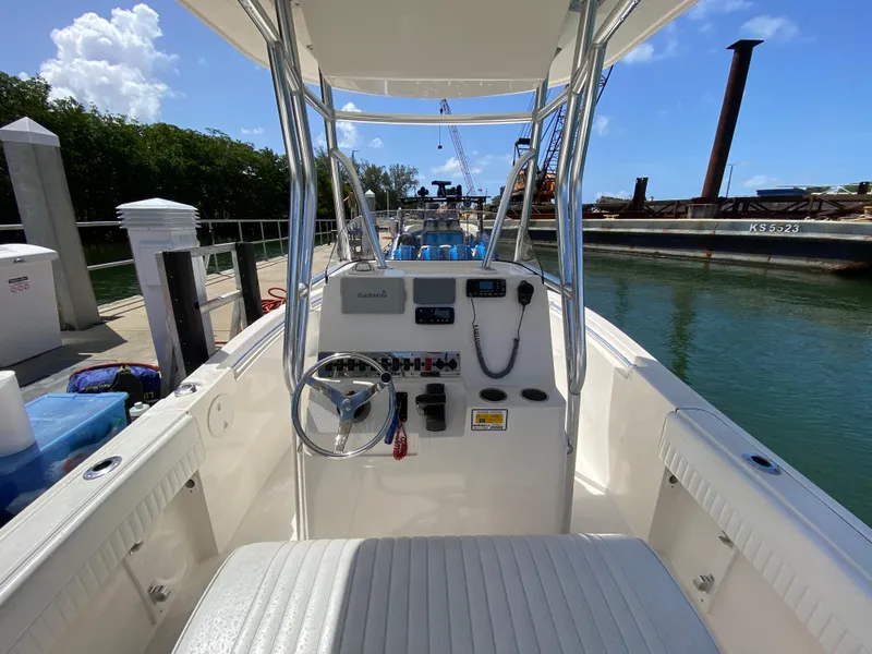 Slide: The Image of 2018 Release 208 SXC boat interior with steering wheel and control panel at dock. - 12