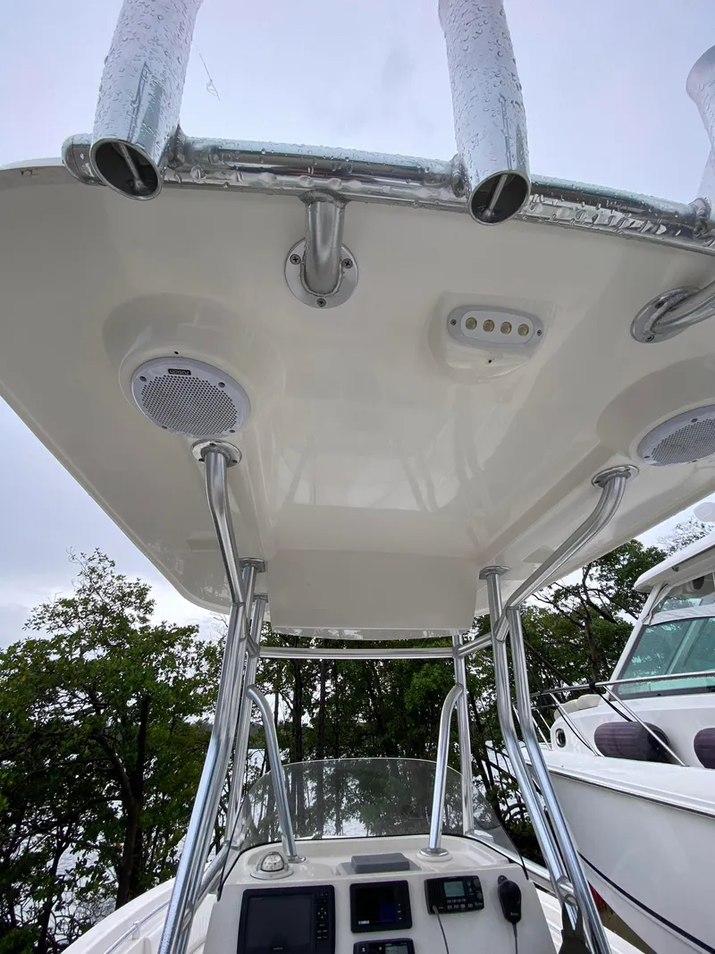 Slide: The Image of 2018 Release 208 SXC boat with T-top, speakers, and rod holders. - 9