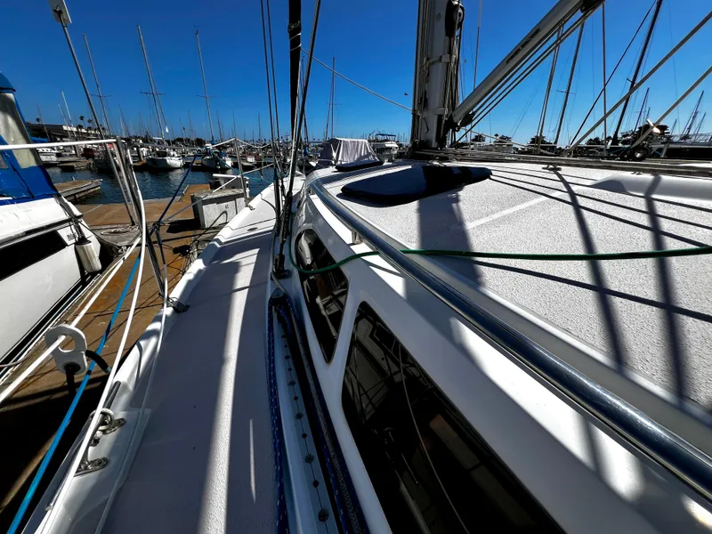 Slide: The Image of 2007 Catalina 350 sailboat docked in a marina under clear blue skies. - 14