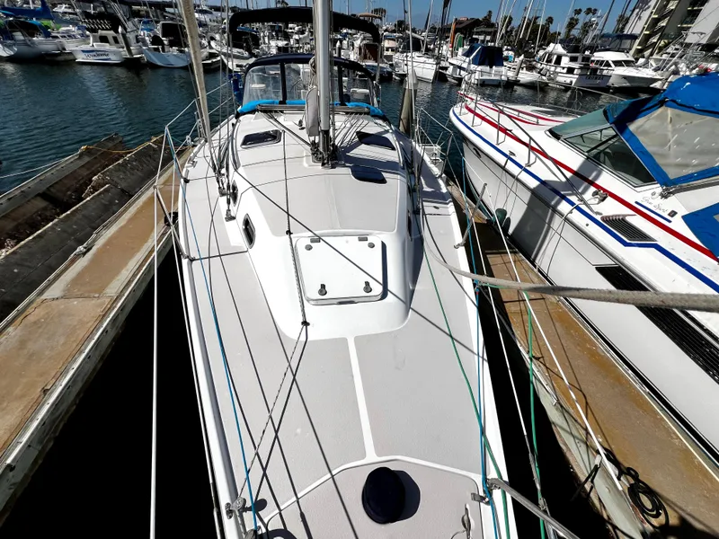 Slide: The Image of 2007 Catalina 350 sailboat docked in a marina, surrounded by other boats. - 15