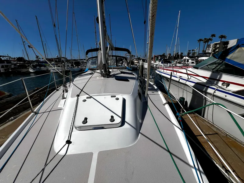 Slide: The Image of Sailboat deck view of 2007 Catalina 350 docked in marina under clear blue sky. - 16