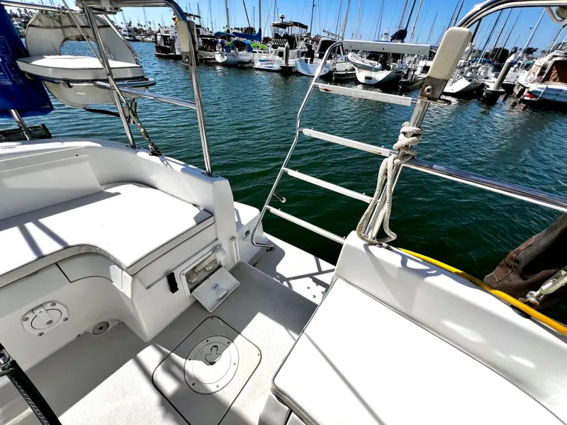 Slide: The Image of 2007 Catalina 350 sailboat cockpit with marina view, featuring seating and nautical equipment. - 20