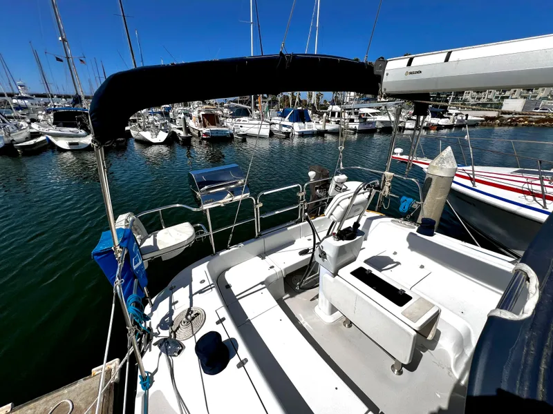 Slide: The Image of 2007 Catalina 350 sailboat docked in a marina, surrounded by other boats. - 21