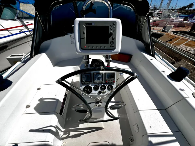 Slide: The Image of Cockpit of a 2007 Catalina 350 sailboat with navigation equipment and steering wheel. - 25