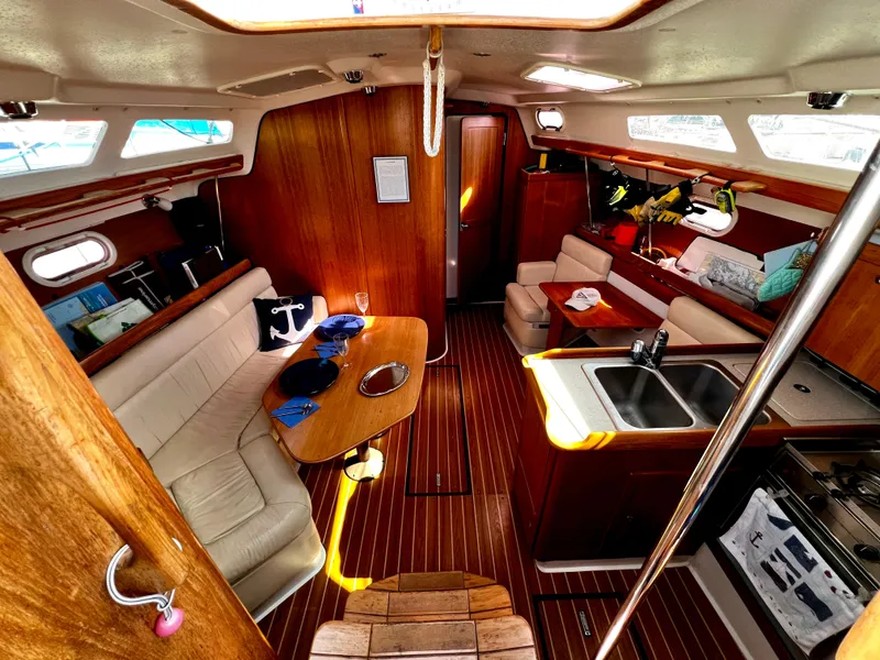 Slide: The Image of Interior of a 2007 Catalina 350 sailboat with cozy seating and wooden finishes. - 32