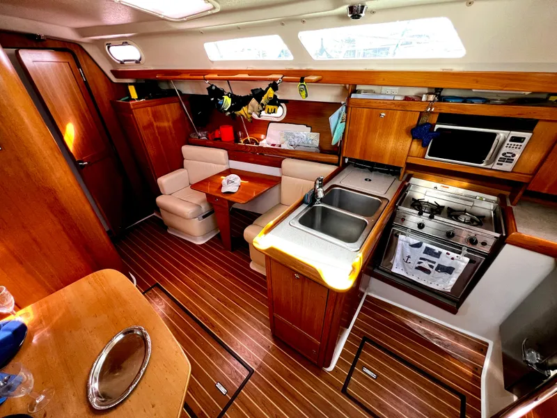 Slide: The Image of Interior of 2007 Catalina 350 sailboat with kitchen and dining area. - 38