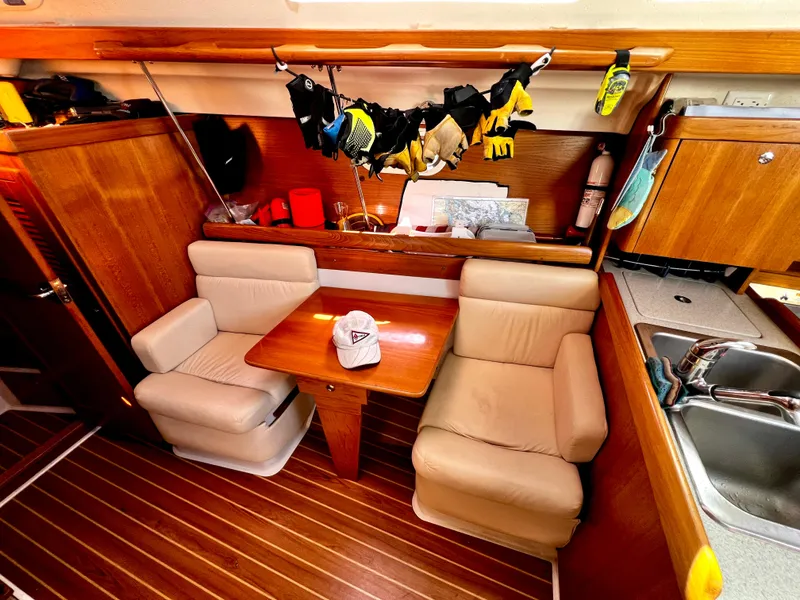 Slide: The Image of Interior of 2007 Catalina 350 sailboat with cozy seating and wooden finishes. - 39