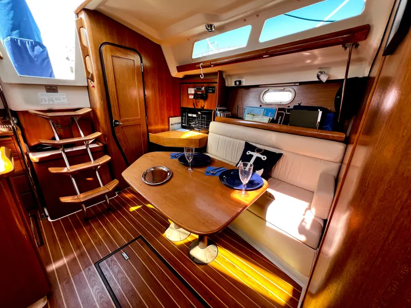 Slide: The Image of Interior of a 2007 Catalina 350 sailboat with wooden finishes and cozy seating area. - 41