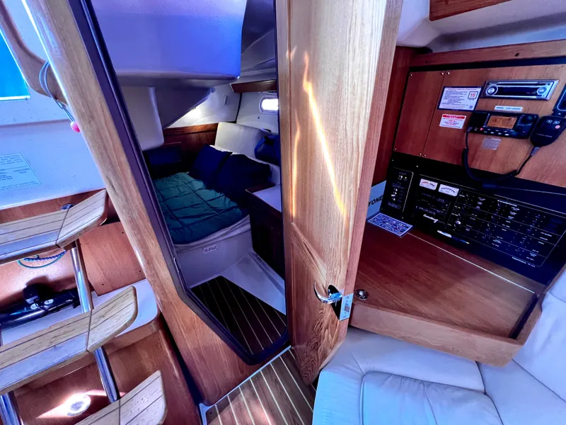 Slide: The Image of Cozy interior of a 2007 Catalina 350 sailboat with a cabin and control panel. - 42