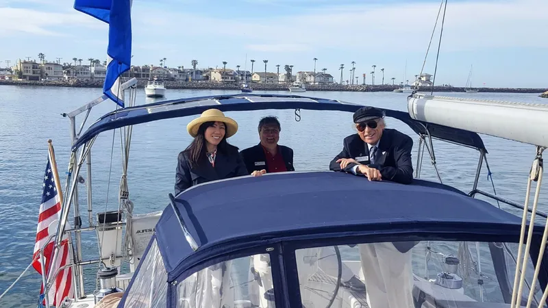 Slide: The Image of Three people enjoying a day on a 2007 Catalina 350 sailboat in a marina. - 7