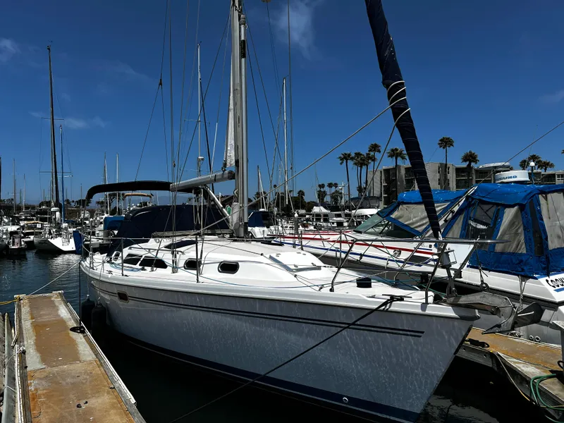 Slide: The Image of 2007 Catalina 350 sailboat docked in marina under clear blue sky. - 9