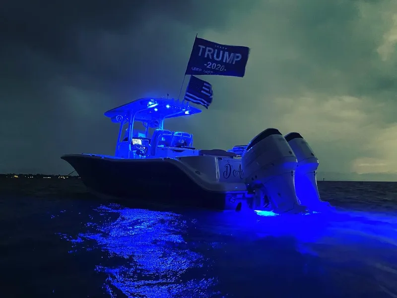 Slide: The Image of 2018 NauticStar 28 XS boat interior with seating and docked at marina. - 10