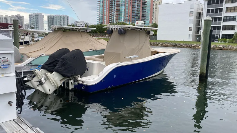 Slide: The Image of Storage compartment in a 2018 NauticStar 28 XS boat with containers and gear. - 14