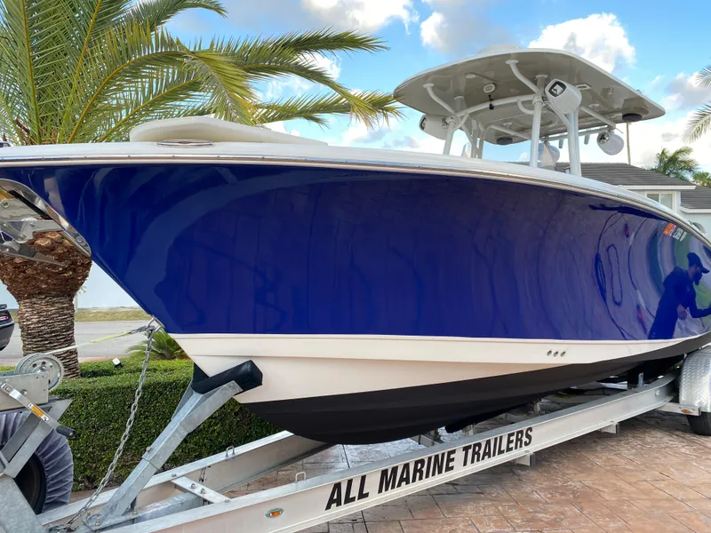 Slide: The Image of 2018 NauticStar 28 XS boat storage compartment with open door and control panel. - 16