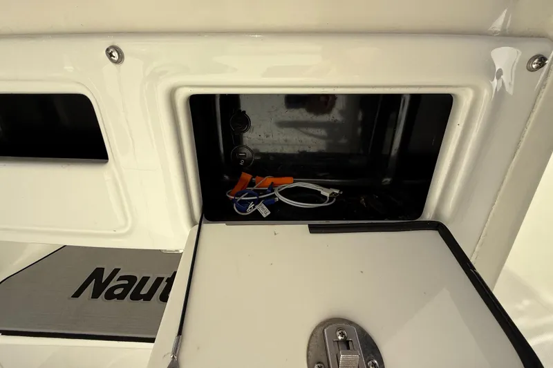 Slide: The Image of 2018 NauticStar 28 XS boat storage compartment with cables and accessories. - 25