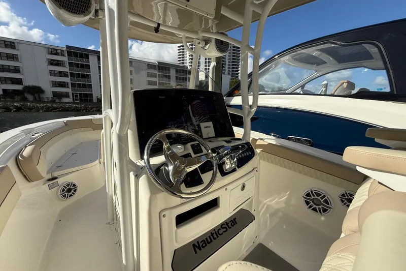 Slide: The Image of 2018 NauticStar 28 XS boat interior with steering console and seating. - 27