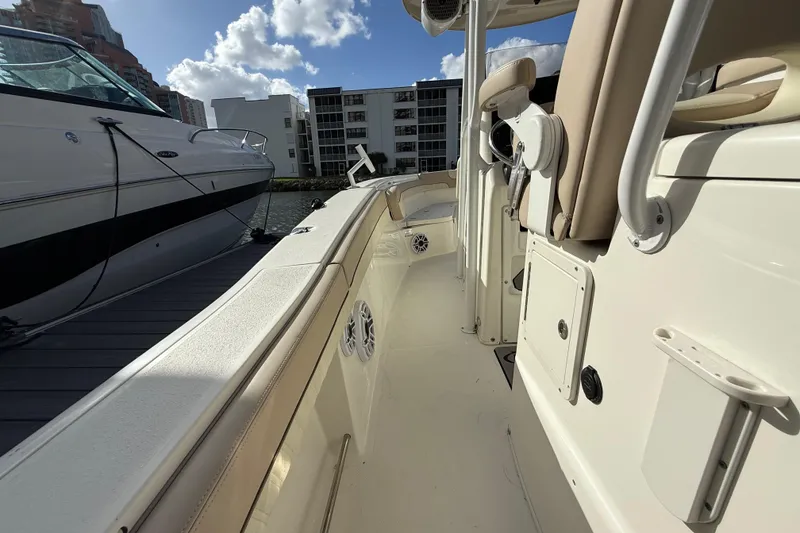 Slide: The Image of 2018 NauticStar 28 XS boat docked, showcasing sleek design and modern features. - 28