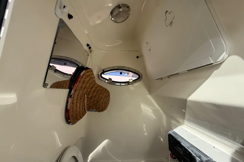 Slide: The Image of Interior cabin of 2018 NauticStar 28 XS boat with porthole and storage. - 30