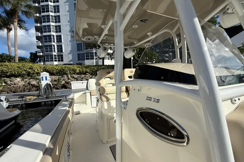 Slide: The Image of 2018 NauticStar 28 XS boat docked near waterfront building. - 33