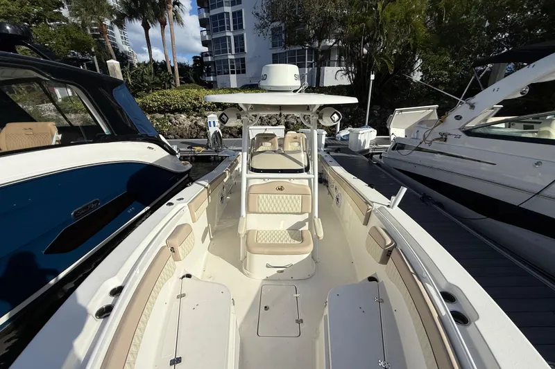 Slide: The Image of 2018 NauticStar 28 XS boat docked, featuring spacious seating and modern design. - 36