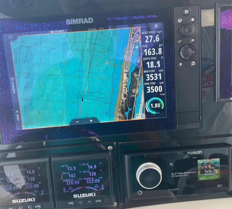 Slide: The Image of 2018 NauticStar 28 XS boat with Suzuki engines docked at marina. - 4