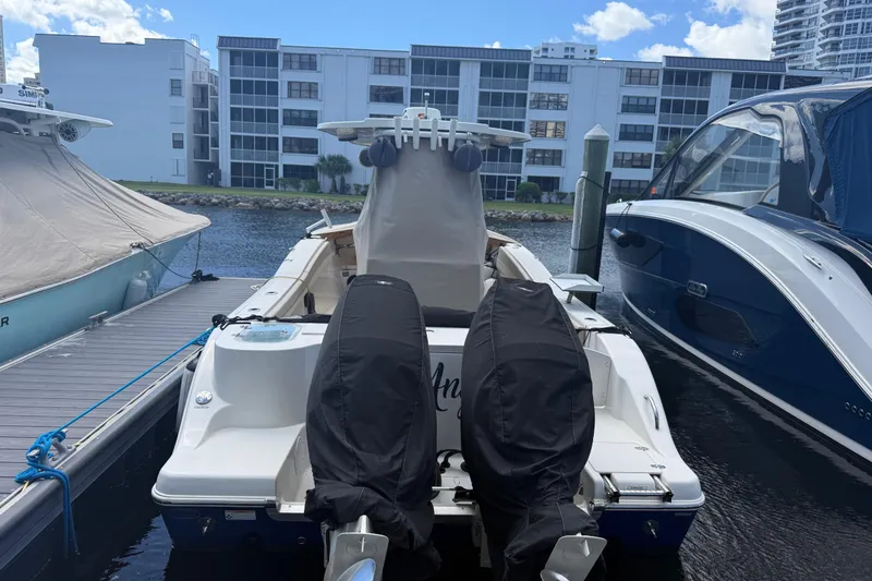 Slide: The Image of 2018 NauticStar 28 XS Offshore boat docked between other vessels. - 45