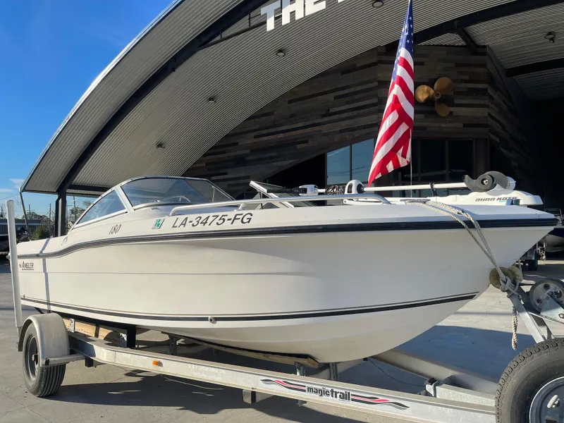 Slide: The Image of 2002 Angler 18 DC boat on trailer at The Boat Yard with American flag. - 4