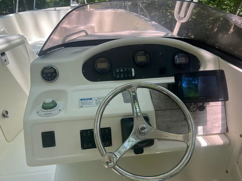 Slide: The Image of 2007 World Cat 266 SD boat dashboard with steering wheel and navigation instruments. - 3