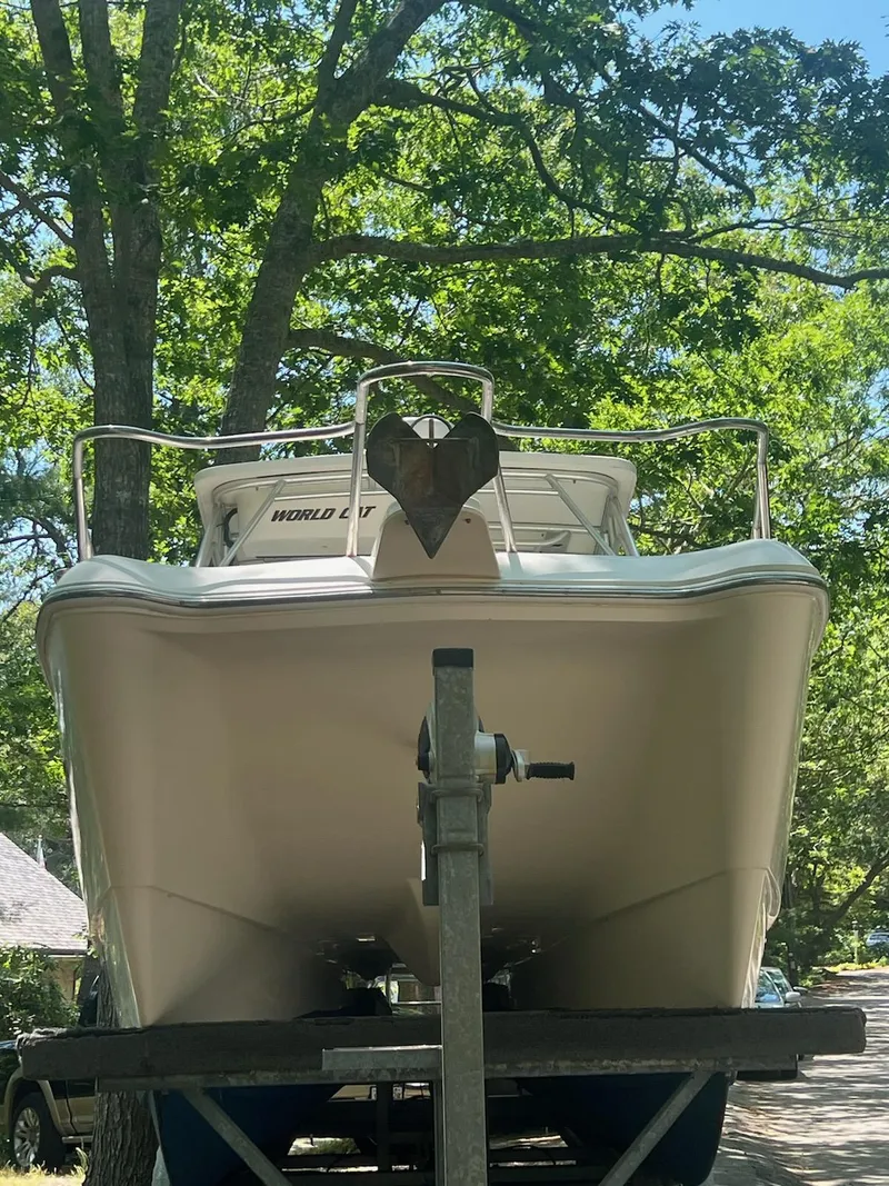 Slide: The Image of 2007 World Cat 266 SD boat on trailer, surrounded by trees. - 4