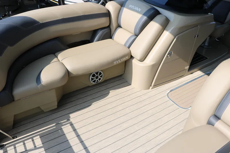 Slide: The Image of 2025 Sylvan L3 RLZ boat interior with beige and gray seating, featuring a speaker. - 14