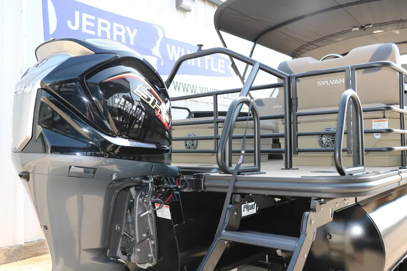 Slide: The Image of 2025 Sylvan L3 RLZ pontoon boat with Yamaha outboard motor, docked at dealership. - 4