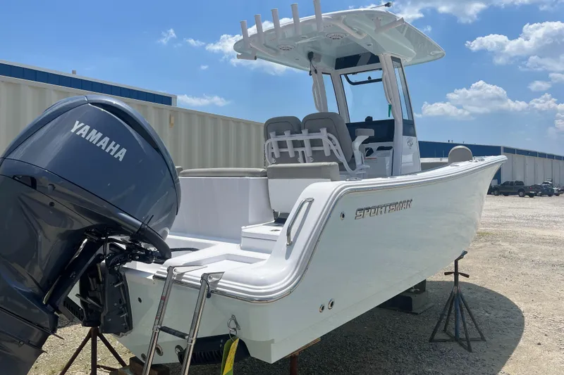 Slide: The Image of 2025 Sportsman Heritage 231 Center Console boat with Yamaha engine, parked outdoors. - 1