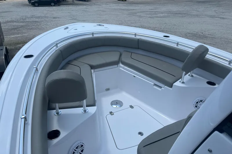 Slide: The Image of 2025 Sportsman Heritage 231 Center Console boat interior with cushioned seating and storage. - 10