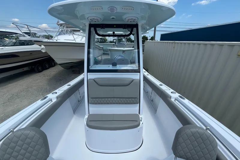 Slide: The Image of 2025 Sportsman Heritage 231 Center Console boat interior with seating and console view. - 11