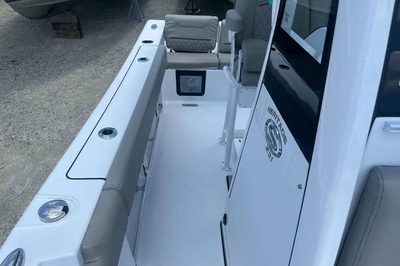 Slide: The Image of 2025 Sportsman Heritage 231 Center Console boat interior with seating and storage. - 13