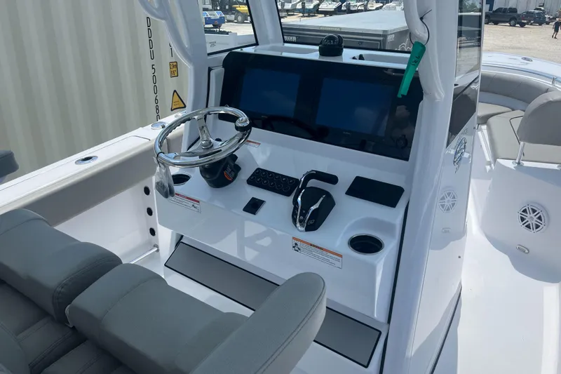 Slide: The Image of 2025 Sportsman Heritage 231 Center Console boat interior with steering wheel and controls. - 4