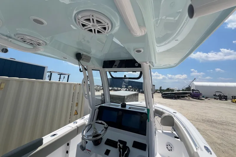 Slide: The Image of 2025 Sportsman Heritage 231 Center Console boat interior with steering wheel and electronics. - 6