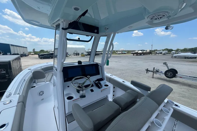 Slide: The Image of 2025 Sportsman Heritage 231 Center Console boat interior with steering wheel and seating. - 7